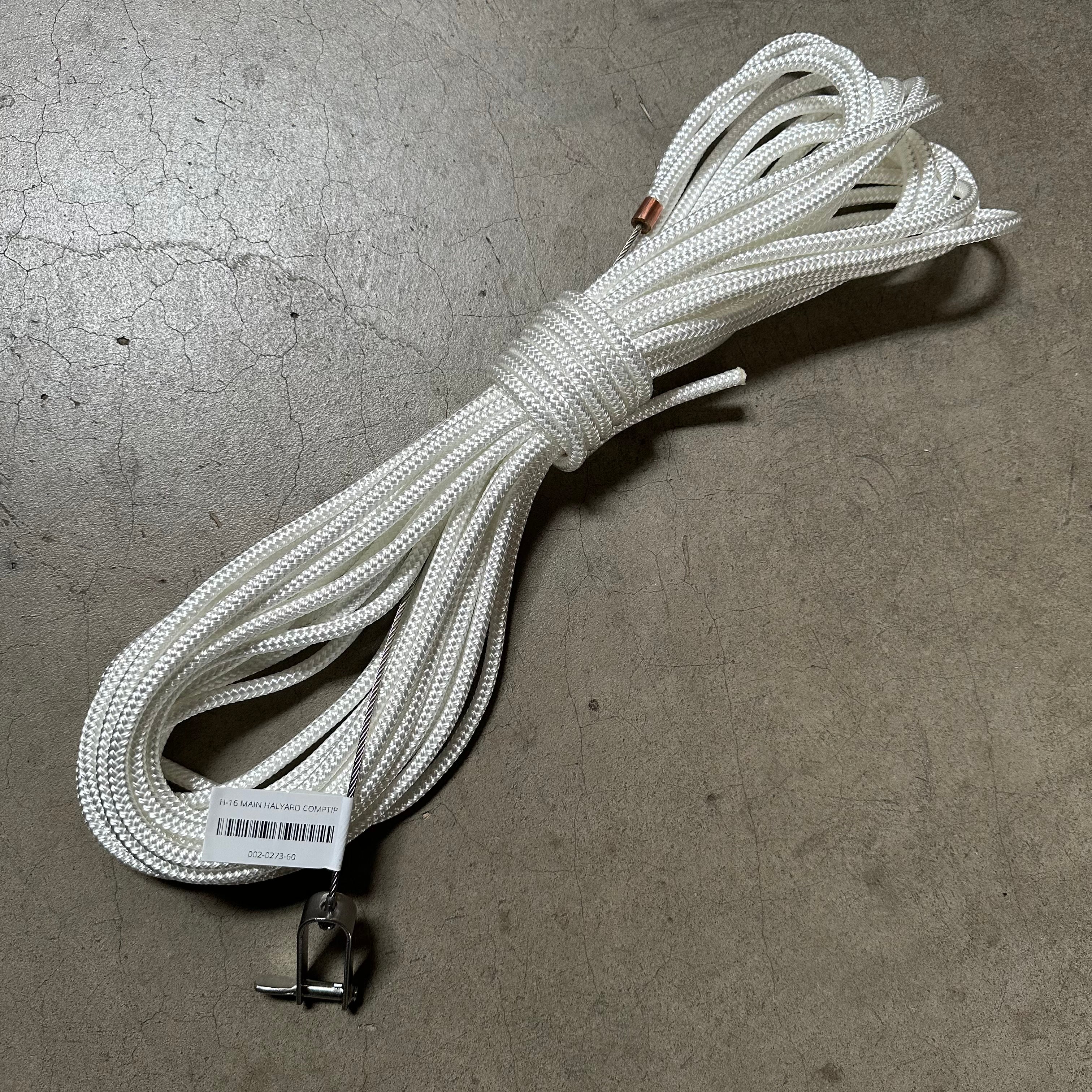 The Hobie 16 main halyard comptip is used to raise the main sail on a Hobie 16 with a comptip on the mast. The main halyard comptip features a long rope section connected to a shorter wire section with a stopper and halyard shackle with a captured pin. The shackle connects to the head of the main sail and the stopper hooks into the main halyard hook and holds the sail up.  
Comptip masts are stock on all Hobie 16s since 1986. A comptip is the 10' fiberglass upper mast section of the mast 20617001