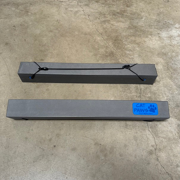 Cat Paws Hull Pads
Murrays PN 13-0031
Cat Paws Hull Pads are foam pads that will protect your catamaran hulls. Similar to hull chocks, but much more versatile. Cat Paws can be used as a mast cradle while trailering, and are perfect for turning your cat on its side in parking lots.  Made from a highly durable closed cell foam that does not absorb water, mold or corrode. Ideal for use on Hobie, Nacra, and Prindle catamarans.
Closed cell foam body with a bungee strap for holding it in