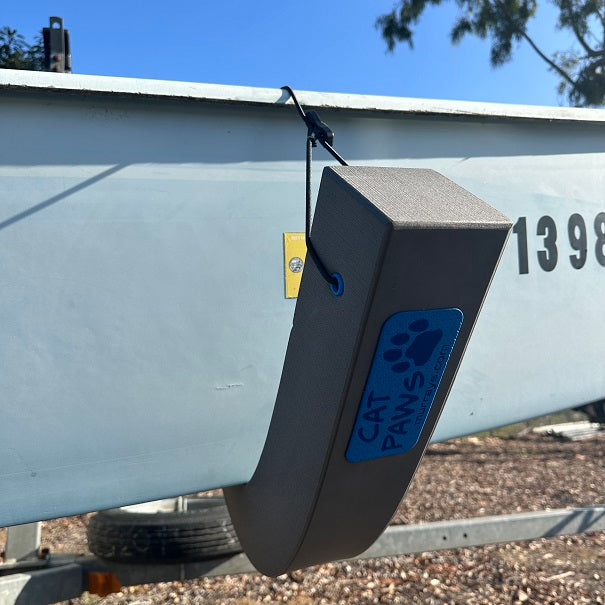 Cat Paws Hull Pads are foam pads that will protect your catamaran hulls. Similar to hull chocks, but much more versatile. Cat Paws can be used as a mast cradle while trailering, and are perfect for turning your cat on its side in parking lots. Made from a highly durable closed cell foam that does not absorb water, mold or corrode. Ideal for use on Hobie, Nacra, and Prindle catamarans.
Closed cell foam body with a bungee strap for holding it in place on your hulls.
Adjustable bungee strap with quick connect