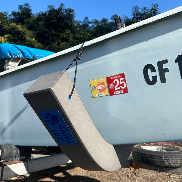 Cat Paws Hull Pads are foam pads that will protect your catamaran hulls. Similar to hull chocks, but much more versatile. Cat Paws can be used as a mast cradle while trailering, and are perfect for turning your cat on its side in parking lots. Made from a highly durable closed cell foam that does not absorb water, mold or corrode. Ideal for use on Hobie, Nacra, and Prindle catamarans.
Closed cell foam body with a bungee strap for holding it in place on your hulls.
Adjustable bungee strap with quick connect