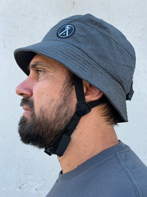 Impact Bucket Hat - Bump Cap

The Surf - Foil Impact Bucket Hat is a bucket hat with a lightweight plastic and foam liner that makes it able to take light to medium impacts. Watersports specific design is great for Surfing, Kitesurfing, Foiling, Sailing, SUP, Kayak, and Windsurfing.

- 360 degree brim with a stiff section in the front to protect your face and eyes from the sun.

- Removable neck flap for additional sun protection

- Chin strap for secure fit

- Padded liner for impact resistance