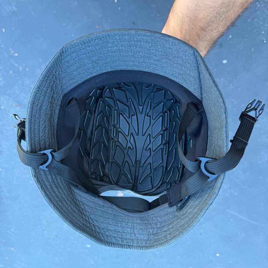 Impact Bucket Hat - Bump Cap

The Surf - Foil Impact Bucket Hat is a bucket hat with a lightweight plastic and foam liner that makes it able to take light to medium impacts. Watersports specific design is great for Surfing, Kitesurfing, Foiling, Sailing, SUP, Kayak, and Windsurfing.

- 360 degree brim with a stiff section in the front to protect your face and eyes from the sun.

- Removable neck flap for additional sun protection

- Chin strap for secure fit

- Padded liner for impact resistance